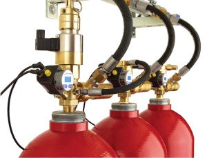 Inert valves IG-541, IG-55, IG-100, IG-01 VDS cetified Three red fire extinguisher cylinders connected with black hoses and brass metal fittings, shown against a white background.